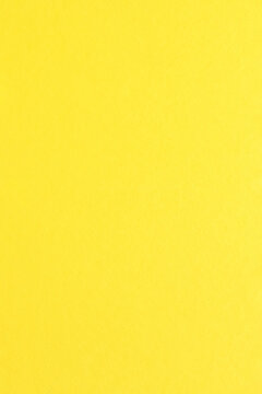 Yellow color paper background with simple surface.