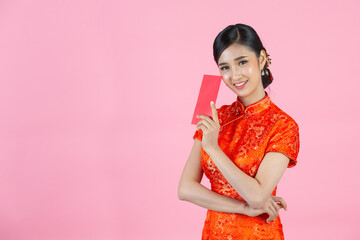 beautiful Asian woman show something and take red envelopes in chinese new year