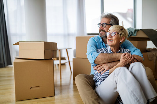 Portrait of happy senior couple in love moving in new home