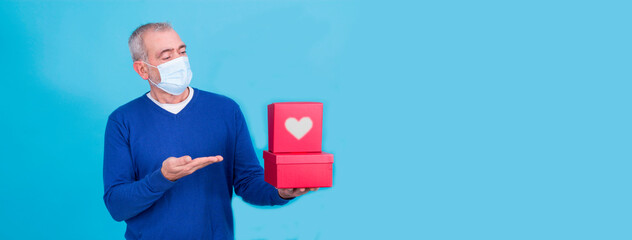 attractive man with protective mask on his face for coronavirus or covid-19 and present concept...