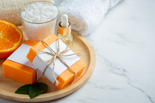 Orange soap with fresh orange on marble background