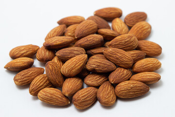 Almonds on a white background. Isolated almonds. Heap of roasted almonds