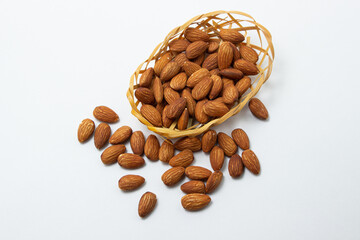 Almonds on a white background. Isolated almonds. Roasted almonds in a small basket