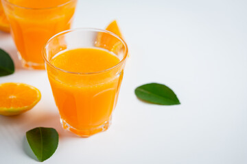 Fresh orange juice in the glass on marble background