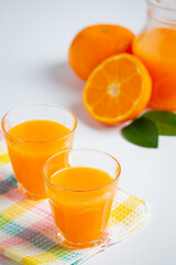 Fresh orange juice in the glass on marble background