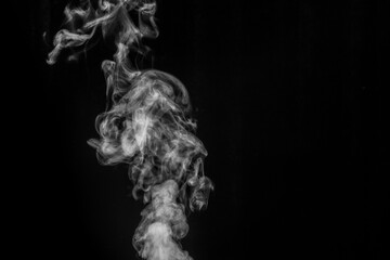 White smoke on black background. Figured smoke on a dark background. Abstract background, design element, for overlay on pictures