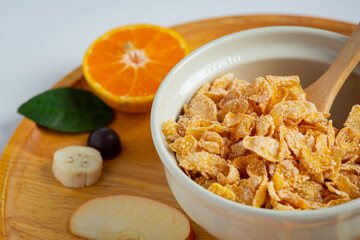  Cereal in bowl and mixed fruit on marble background