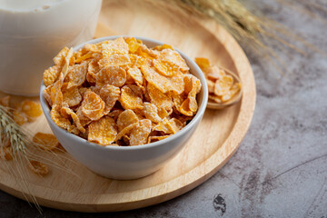 Cereal in bowl and milk on dark background
