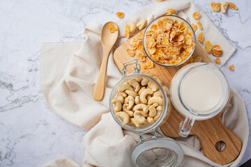 Cereal in bowl and milk on marble background