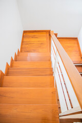 Staircase, wooden floor and black iron rail.