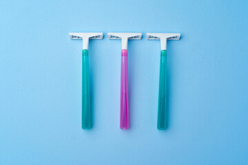Set of disposable razors for women on blue background