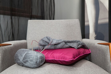 Hand knitting lying on an armchair.