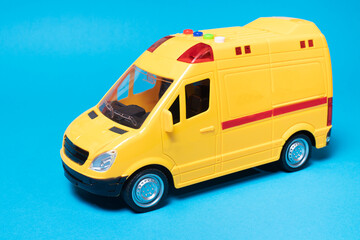 The toy van is yellow with flashing lights on a blue background with a place for copyspace text for the toy store