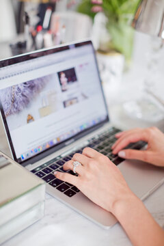 Womans hand on laptop keyboard