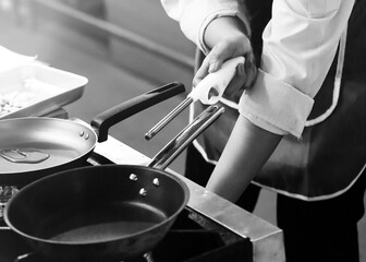 Chef cooking in a kitchen, chef at work, Black and White.