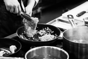 Chef cooking in a kitchen, chef at work, Black and White.
