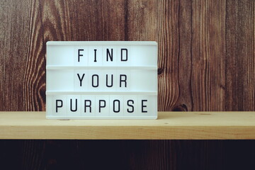 Find Your Purpose word in light box on wooden background