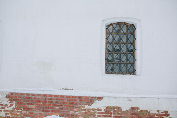 Window with bars on a white wall. 