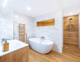 Clean bright bathroom interior with wooden floor, white toilet and marble tiles. Original designed...