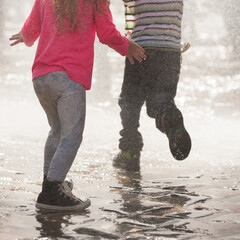 wet kids enjoy and run under the summer rain