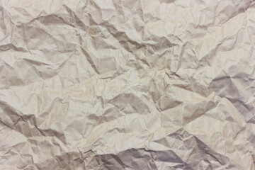 The texture of crumpled brown craft paper.