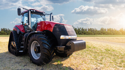 Red tractor on a agricultural field 
