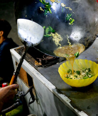 Indonesian hawker street food cooking noodle frying at night