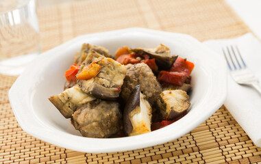 dish of vegetable stew. stewed eggplant, minced meat, carrots, peppers, onion squid