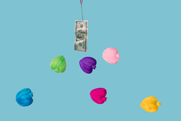 One hundred dollar bill on fish hook surrounded by hearts in different colors. Blue water background.