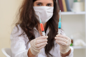 young nurce holding many syringe with medication