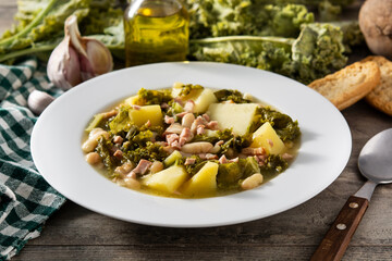 Creamy Tuscan soup in bowl on wooden table