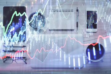 Double exposure of forex graph hologram over desktop with phone. Top view. Mobile trade platform concept.