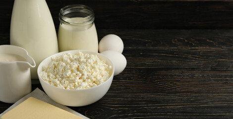 Different fresh dairy products on wooden background, space for text