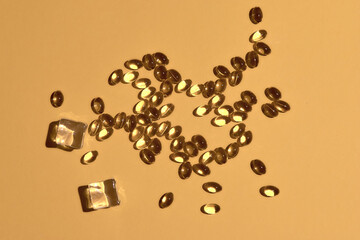 Many transparent pills Omega 3 or fish oil on a colorful background. Health supplements and medicines