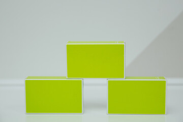 Three green cardboard boxes, standing on the table