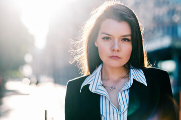 Businesswoman standing outdoors on the street.