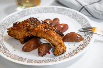 Fish carp with potato on plate.