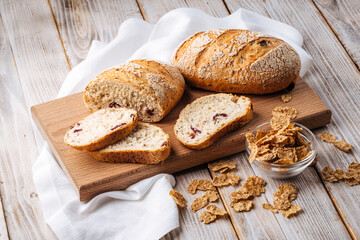 Side view on sliced muesli cereal bread on the wooden cutting board