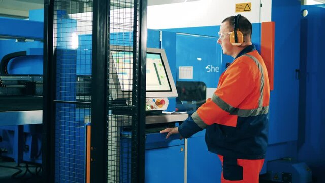 Male operator and an industrial shearing machine