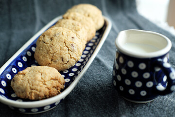 oatmeal cookies on plate and a jug of milk