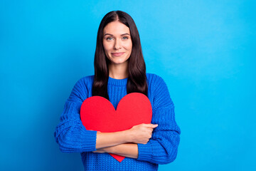 Photo of brunette optimistic nice lady hug paper heart wear blue sweater isolated on bright color...