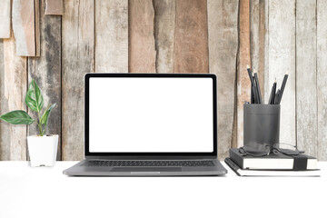 Mockup laptop devices isolated on wood background. personal computer notebook white screen. and notebook, house plant in a pot, notepaper as a desk