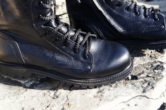 Unisex black boots army with zipped laces on the street