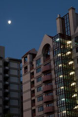 Buildings and moon at sunset. Auckland. North Island. New Zealand.