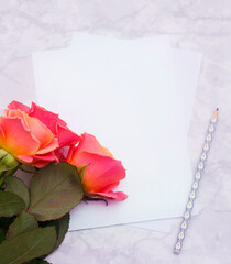 roses on a white background and a blank sheet to write 
