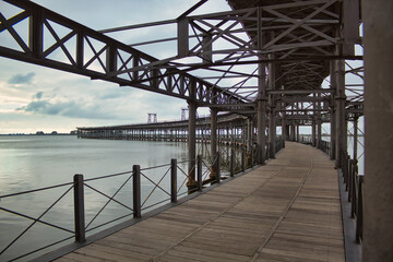 Fototapeta na wymiar Iron bridge over the ocean