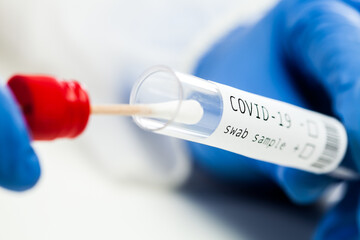 rt-PCR COVID-19 virus disease diagnostic test,UK lab technician wearing blue protective glove...