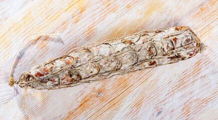 Fototapeta na wymiar Close-up of traditional italian piacenza salami at wooden surface