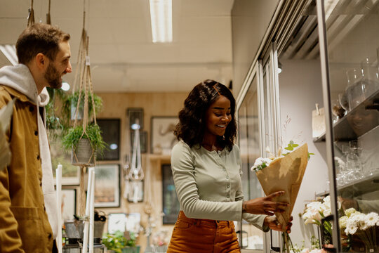 Woman buying flowers in shop