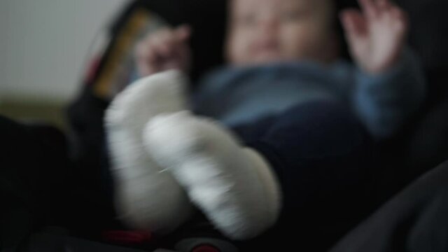 Close view of toddler's feet in white socks moving fast at camera